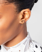 Left Black Diamond Symbol of Change Earring Single on model.