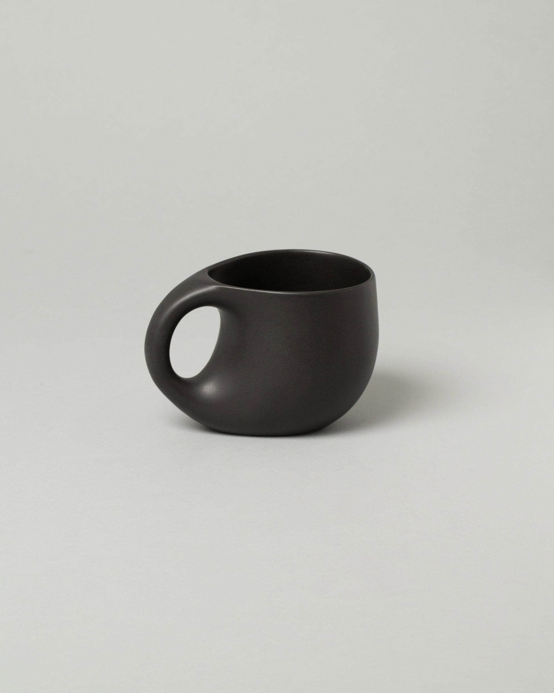 Dust and Form Large Charcoal Comfort Mug on light color background.