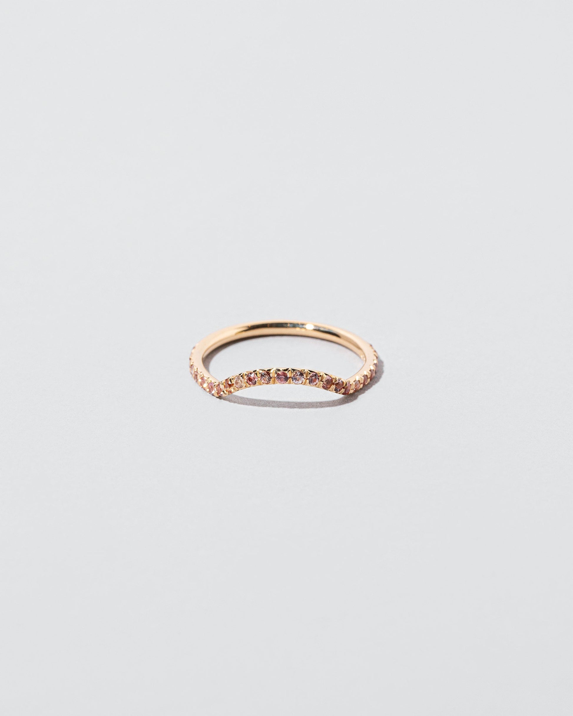  Mini Curve Band with pavé set peach sapphires on light color background.