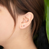 product_details::Oval Frame Stud Earrings on model.