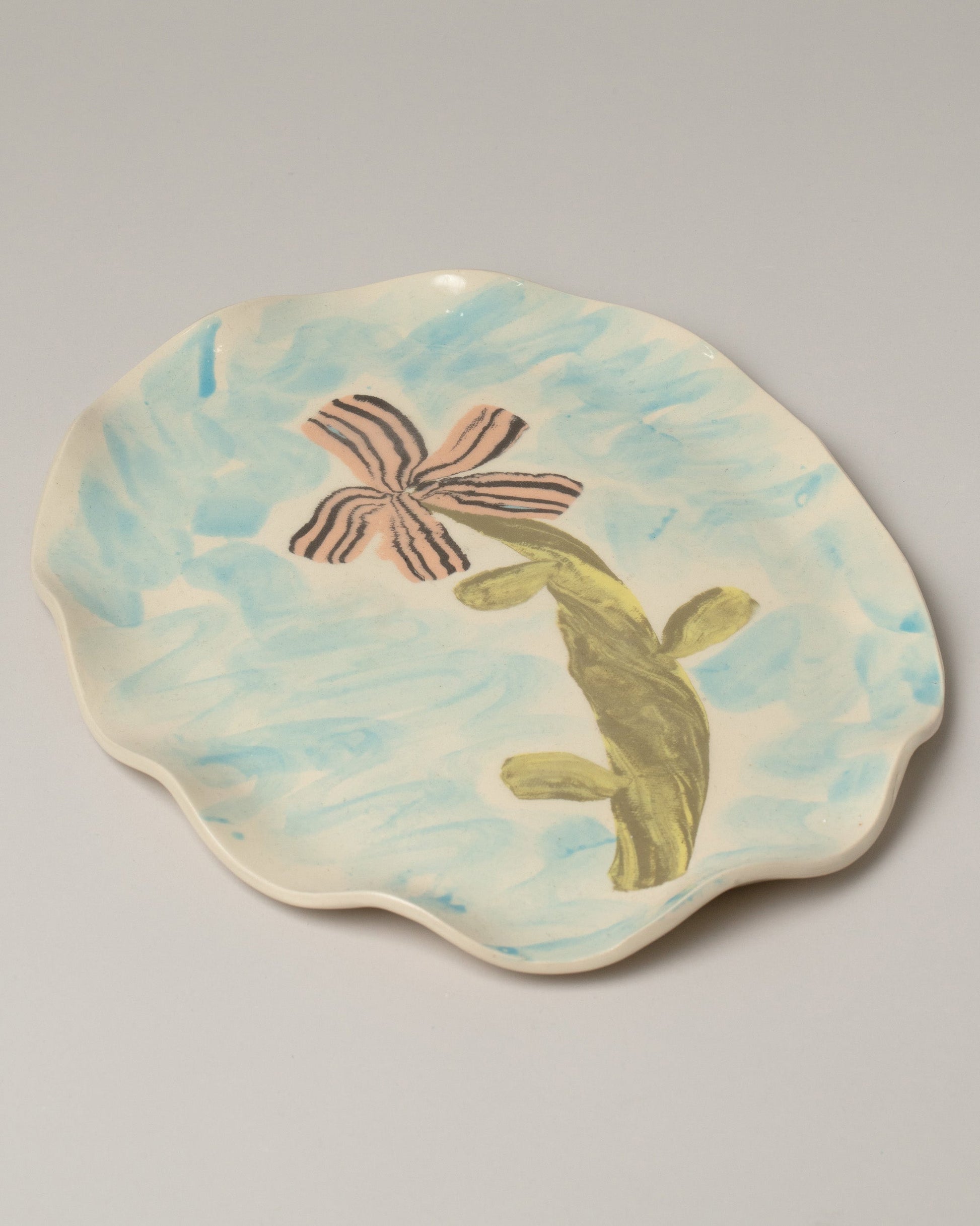 Closeup detail of the E.E. Ceramics Serving Platter - Flower on light color background.