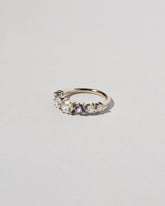  Diamond & Sapphire Line Cluster Ring on light color background.