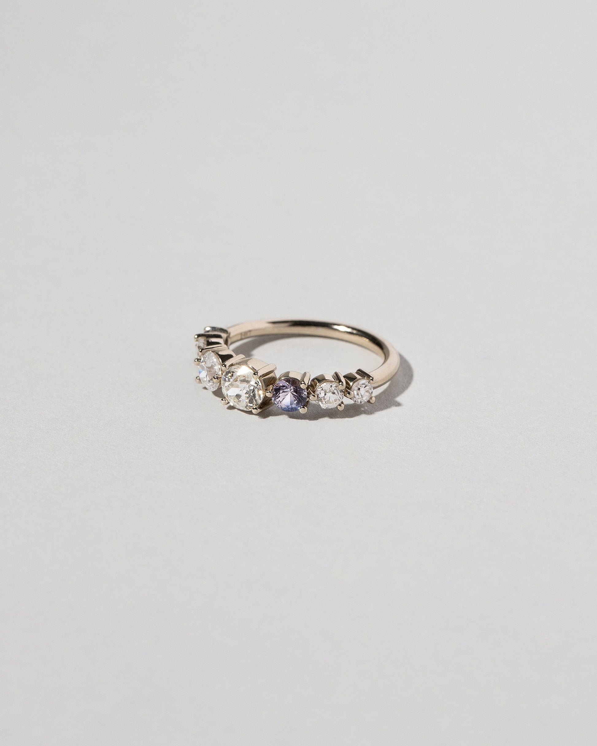 Diamond & Sapphire Line Cluster Ring on light color background.