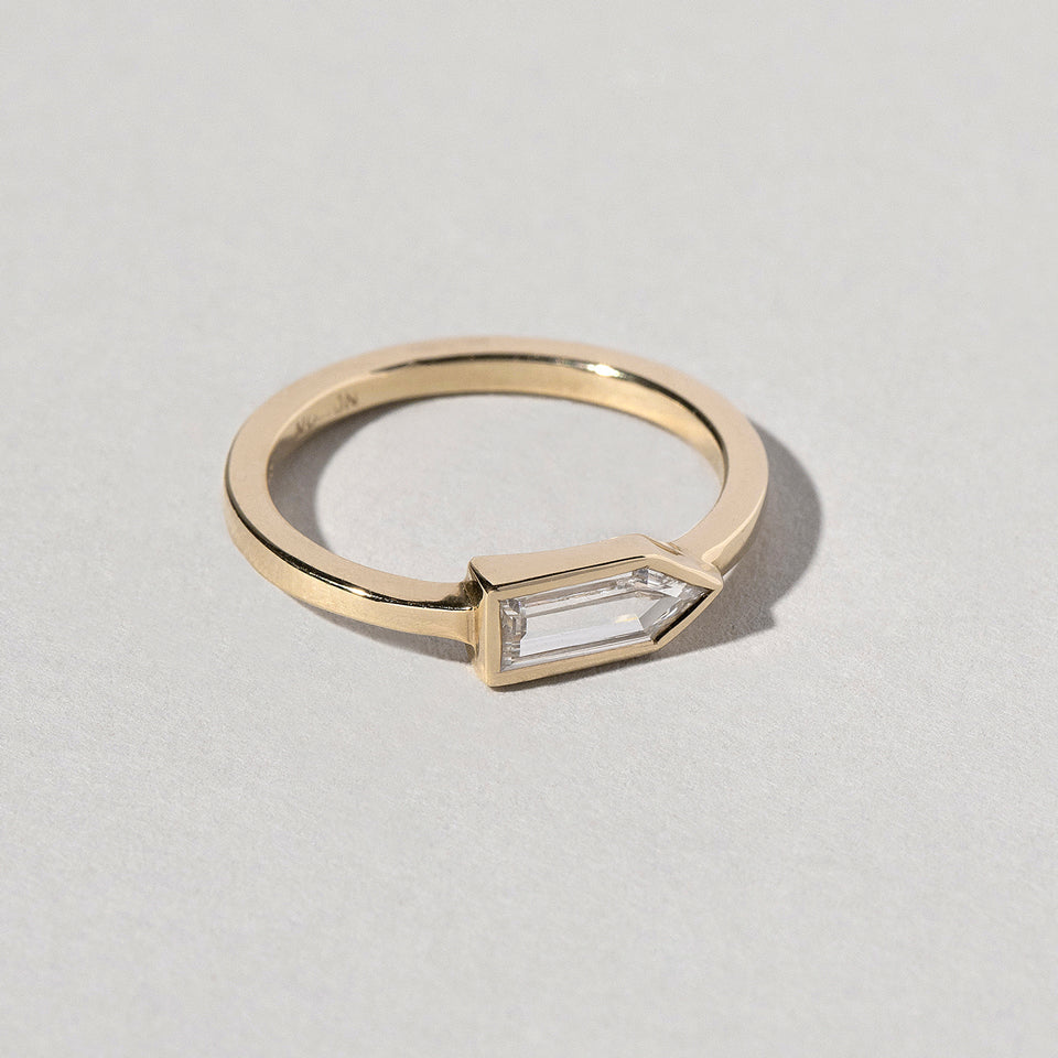 product_details:: Bullet Cut Diamond Ring on light color background.
