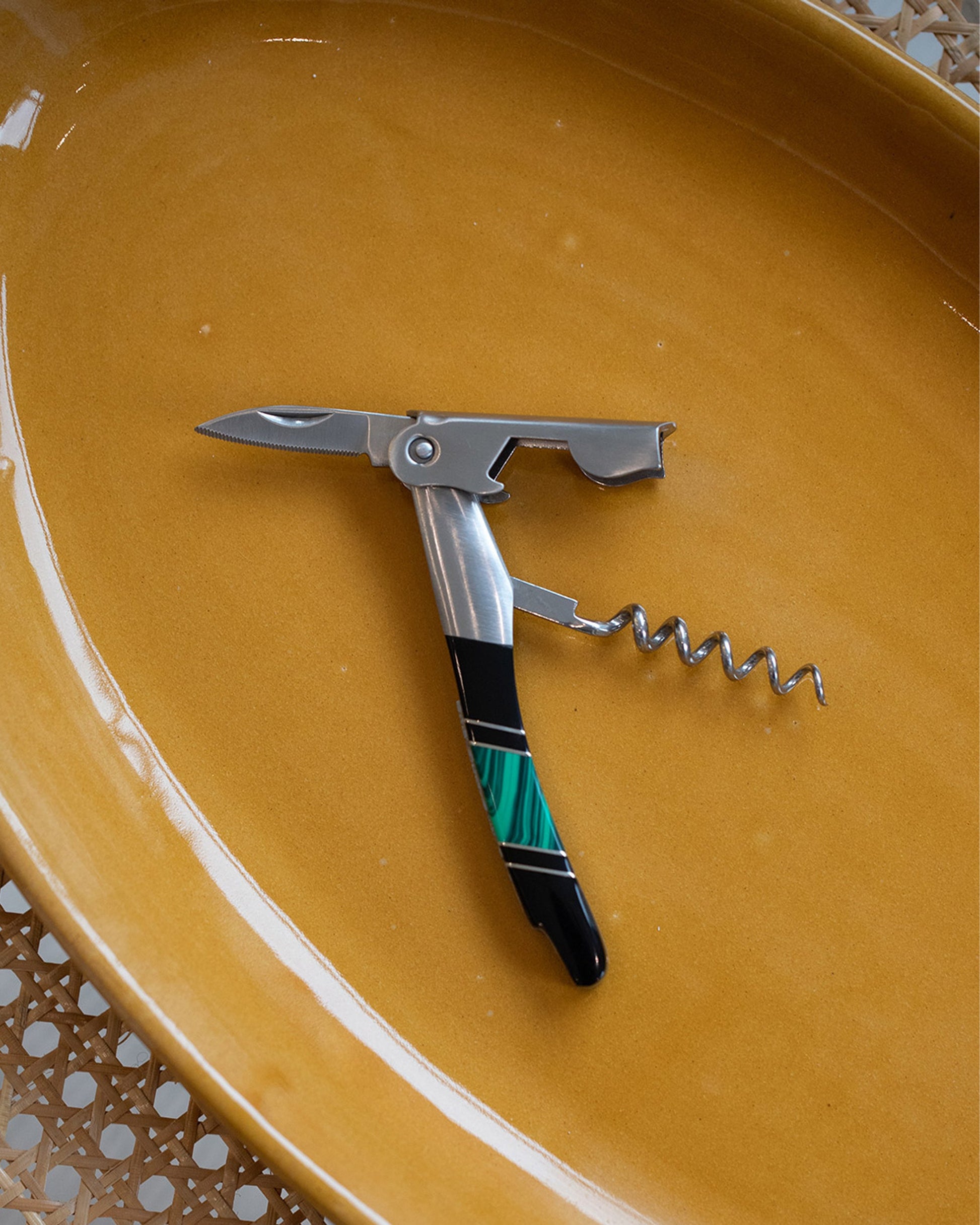 Styled image of the Santa Fe Stoneworks Malachite and Jet Waiter's Knife.