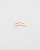 Gold Square Wire Mini Curve Band on light color background.