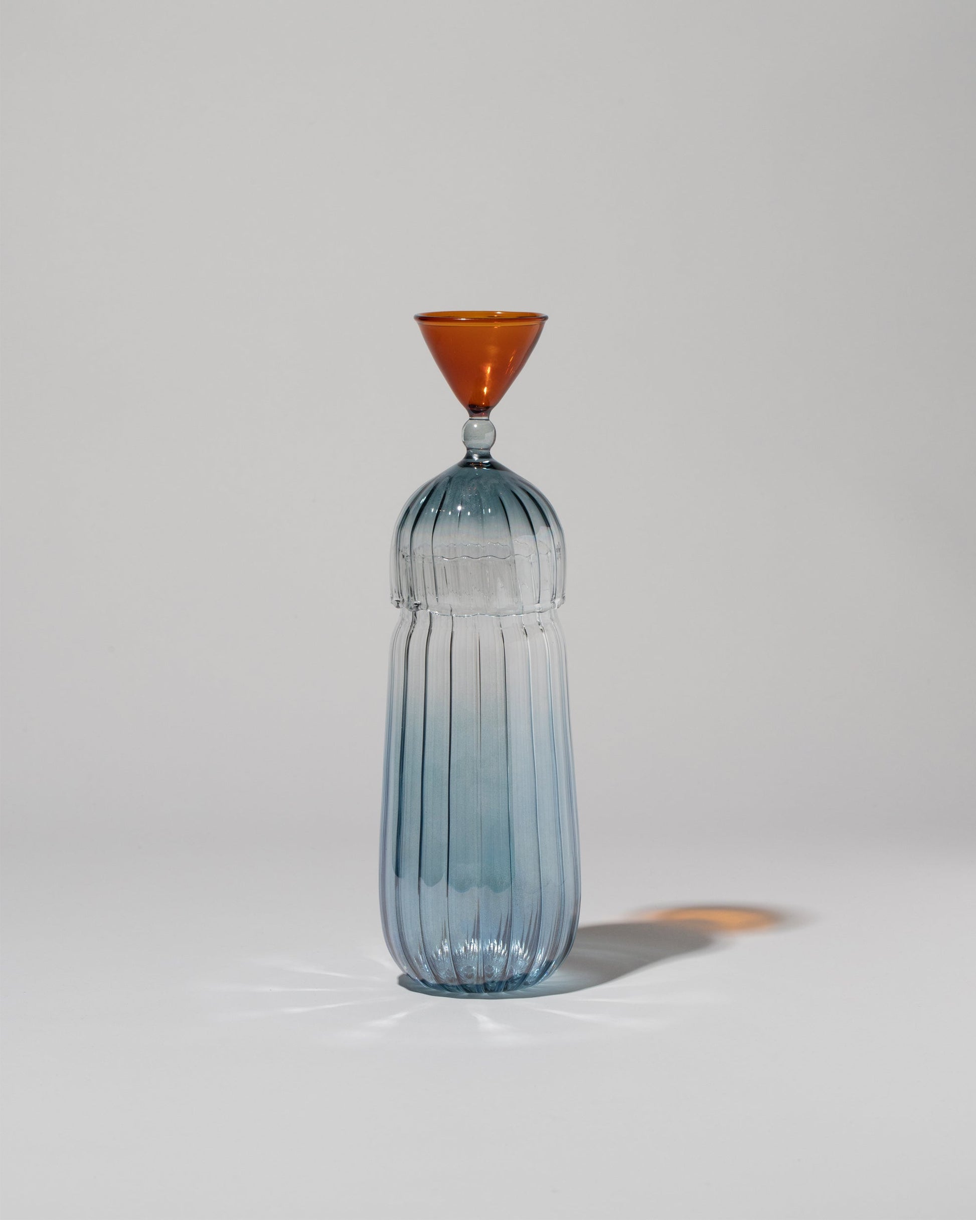  Serena Confalonieri Calypso Bottle & Glass on light color background.