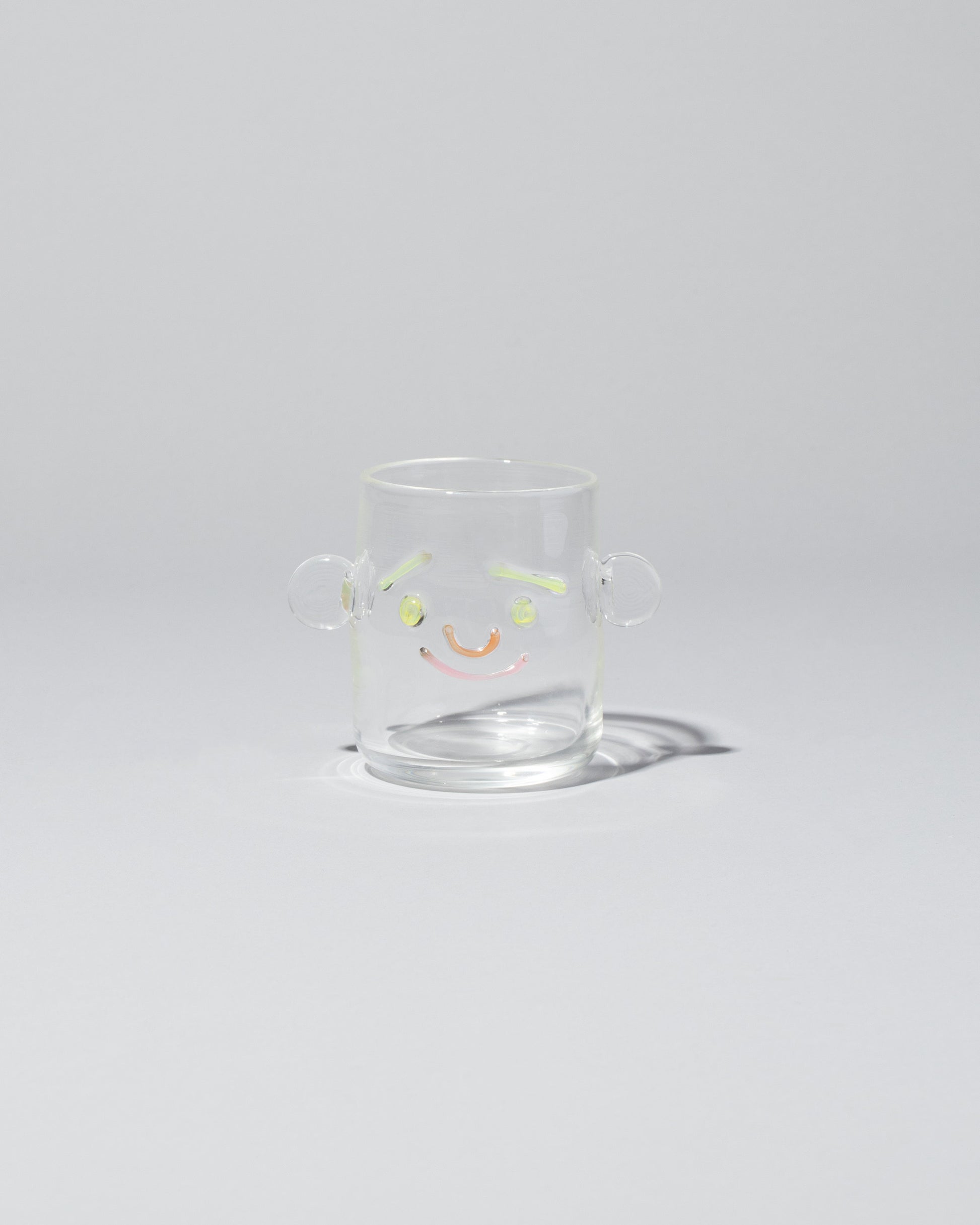 TAK TAK Goods Smiley Face Cup on light color background.