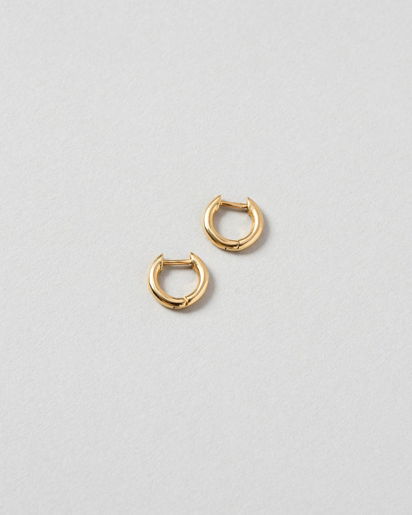 Gold Huggies Solid Snack Hoops on light color background.