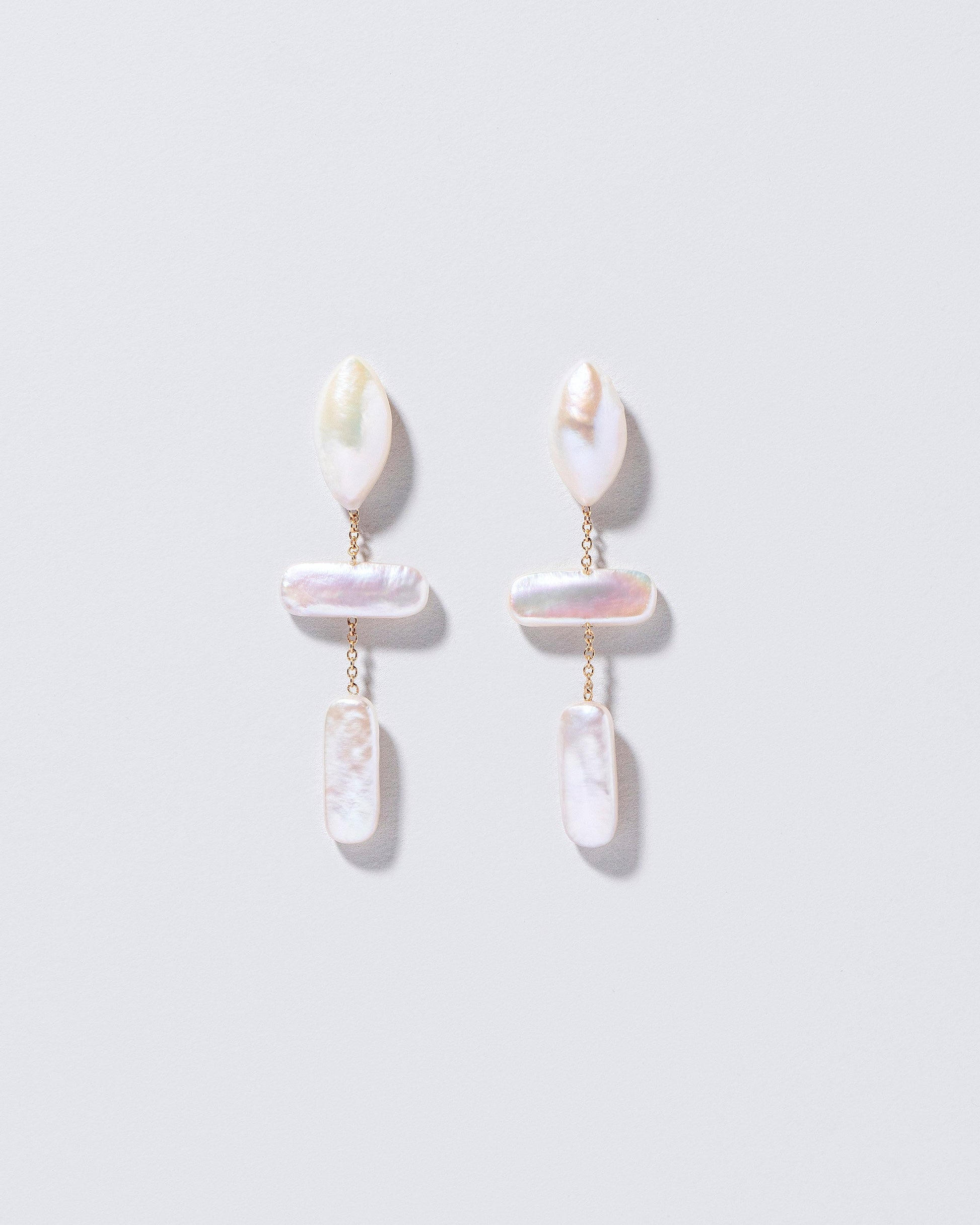  Nauplius Earrings on light color background.