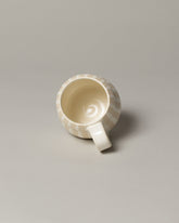 Inside view of the Jeremy Ayers White Bubble Mug on light color background.