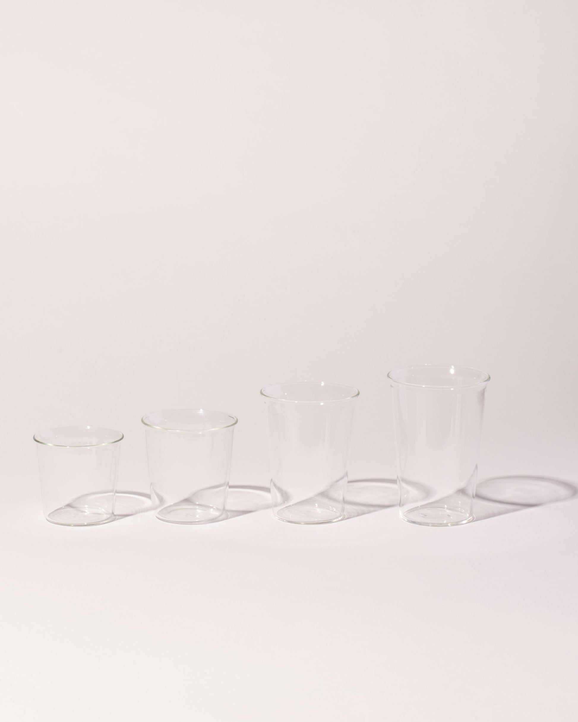 Group of  Kinto Cast Glass Set on light color background.